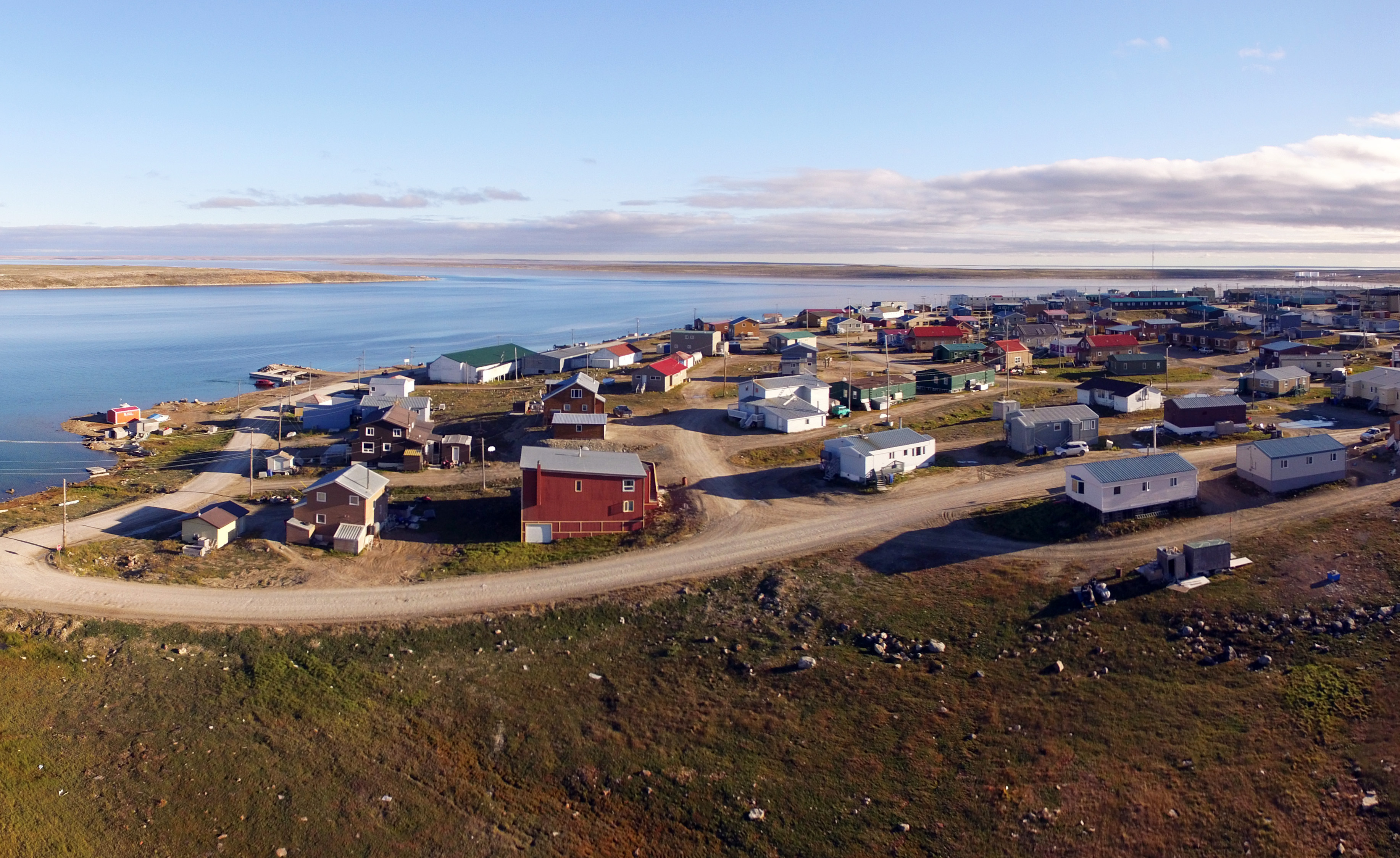 Photo – Small village with water in the background.